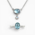 Parure bijoux topaze bleue et argent 925 Duo Azur Céleste, ensemble bague Aura et collier Sillage.